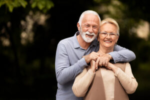 A senior couple hugging each other for a picture