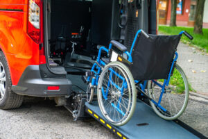 A wheelchair being loaded into an NEMT van