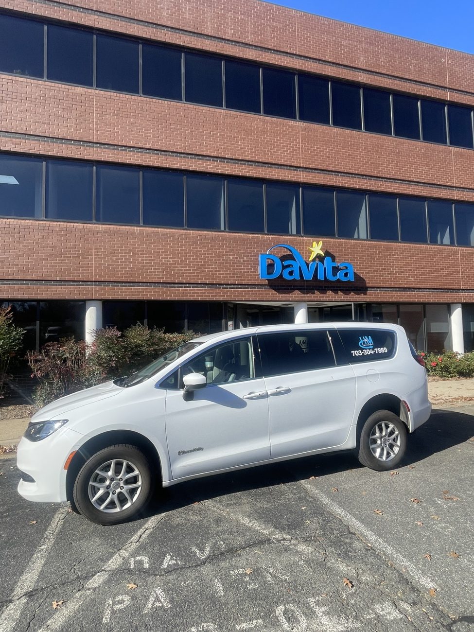 H&M Transport wheelchair van collecting a dialysis patient from a DaVita center