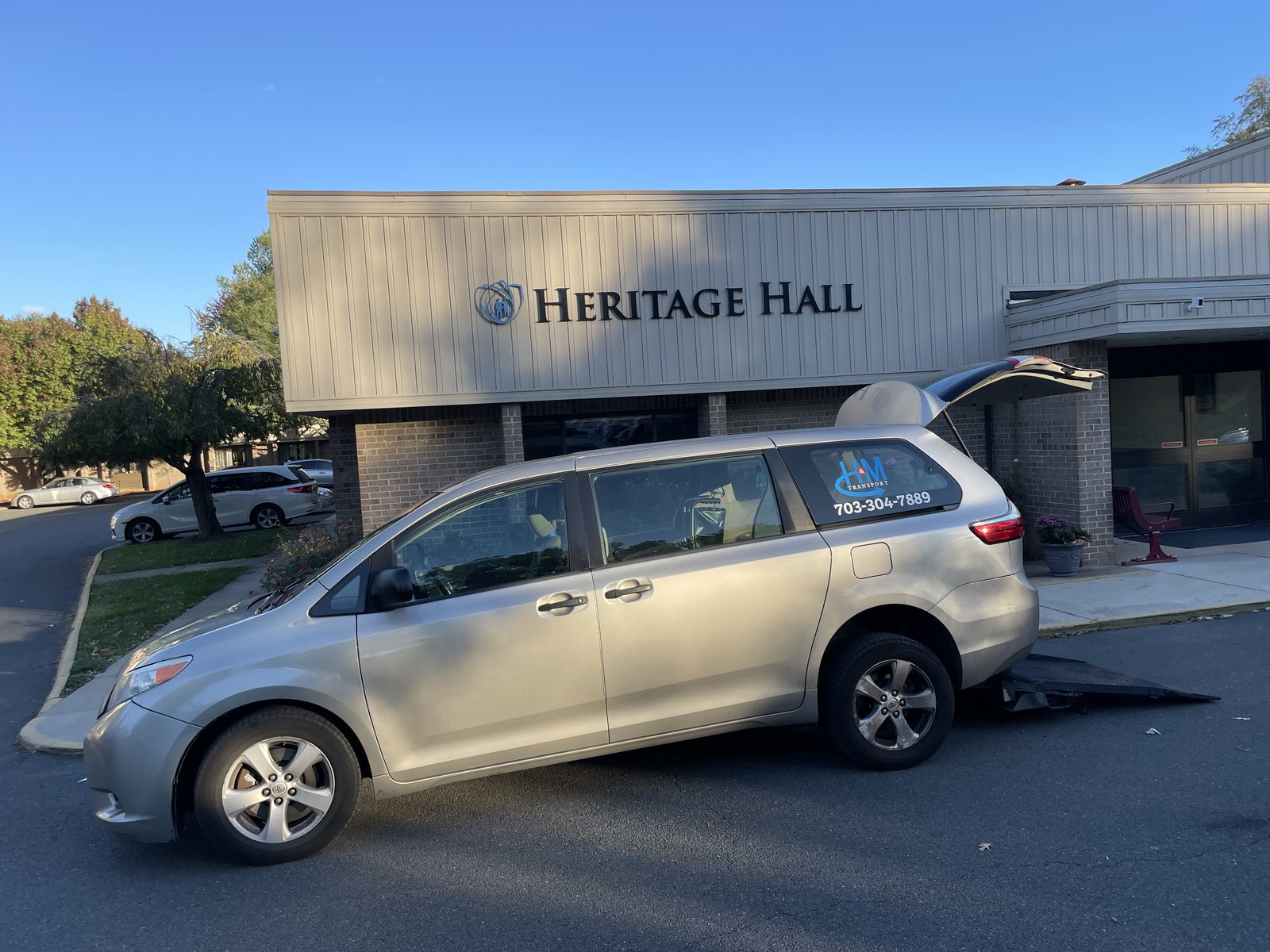 H&M Transport van collecting a resident from a Heritage Hall rehabilitation center